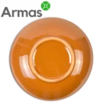 Glazēta oranža keramikas šķīvja apakšpuse – roku darbs