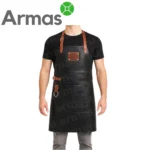 Ādas grila priekšauts no dabīgas melnas ādas ar brūnām detaļām un metāla gredzenu – ideāli piemērots BBQ, virtuvei un dāvanai pavāram.